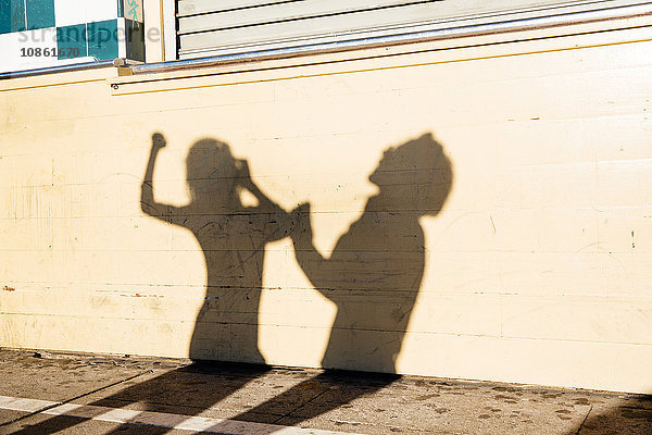 Schatten an der Wand eines tanzenden Paares  im Freien