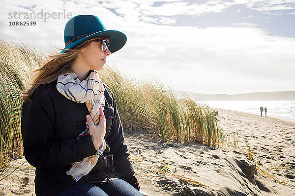 Frau mit Filzhut und Sonnenbrille mit Blick aus den Dünen  Dillon Beach  Kalifornien  USA