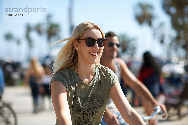 Junge Frau und ihr Freund radeln am Venice Beach  Los Angeles  Kalifornien  USA