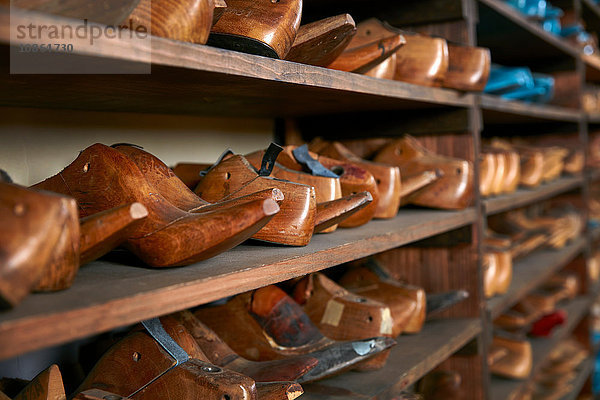 Reihen von alten Holzschuhleisten in den Regalen eines traditionellen Schuhgeschäfts  selektiver Fokus