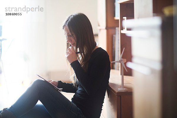 Junge Frau zu Hause  schaut auf Notebook