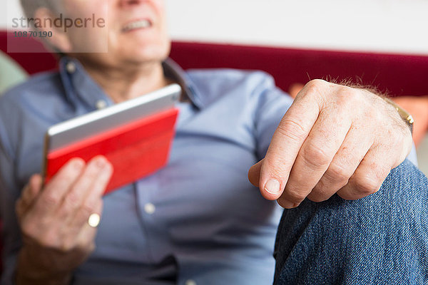 Mann benutzt digitales Tablett zu Hause