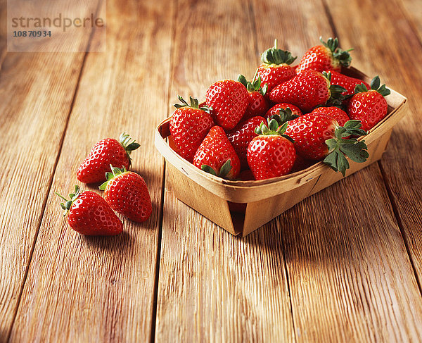 Punnet von Erdbeeren auf Holztisch
