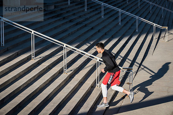 Junger Mann trainiert  rennt die Stadttreppe hinauf