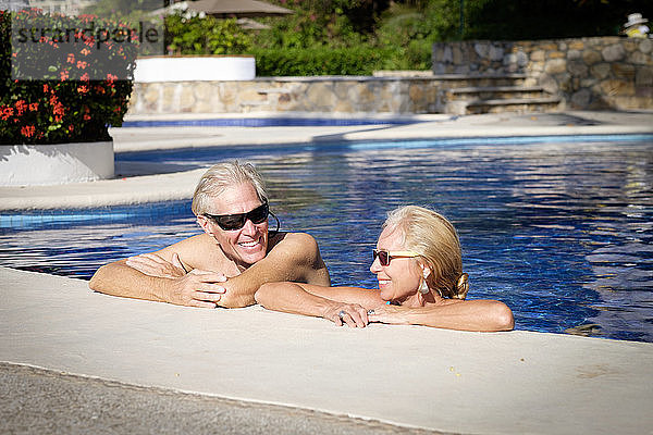 Happy senior couple in swimming pool