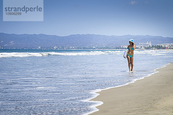 Mexico  Nuevo Vallarta  teenage girl walking at the beach