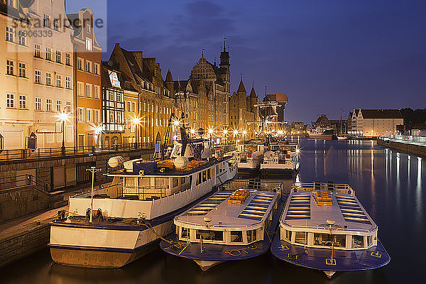 Poland  Gdansk  view to the Old Town by night with moored tourboats in the foreground