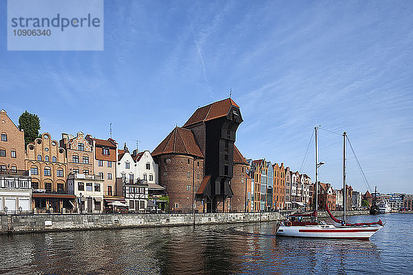 Poland  Gdansk  Motlawa bank with crane gate and sailing boat on Motlawa River