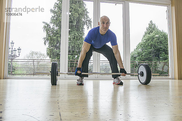 Man trying to lift a barbell
