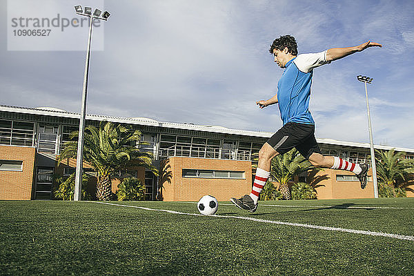 Football player kicking a ball