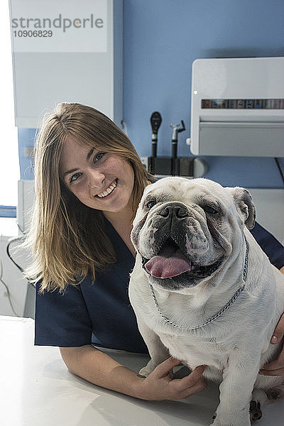 Portrait of smiling veterinarian with dog in a veterinary clinic