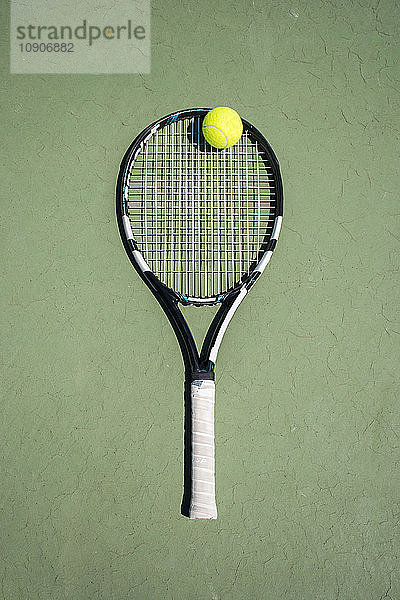 Racket and ball on a tennis court