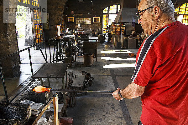 Man working with molten glass in a Factory in Mallorca