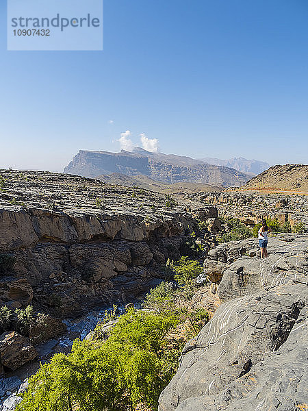 Oman  Jebel Shams  woman standing on viewing point