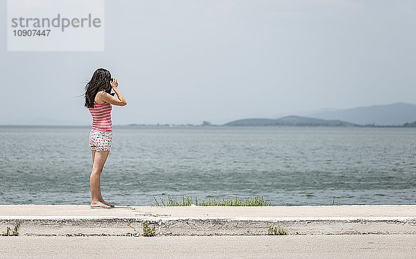 Greece  Amfilochia  woman taking picture at the sea