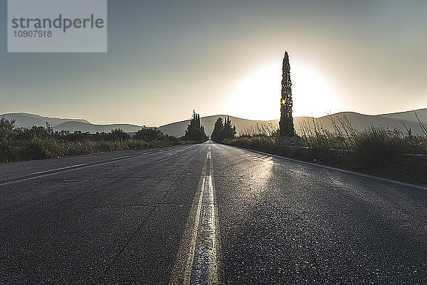 Greece  Mantzari  asphalt road on sunset