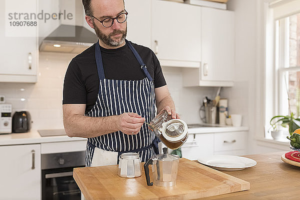 Man preparing espresso in the kitchen