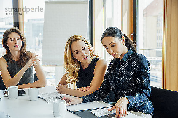 Three businesswomen having a meeting in conference room