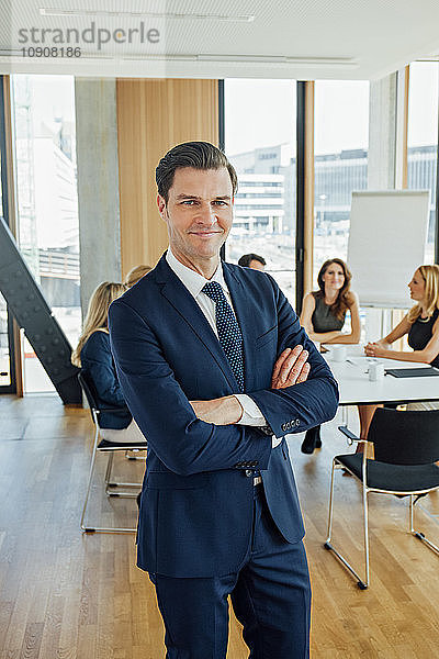 Portrait of confident businessman in a meeting