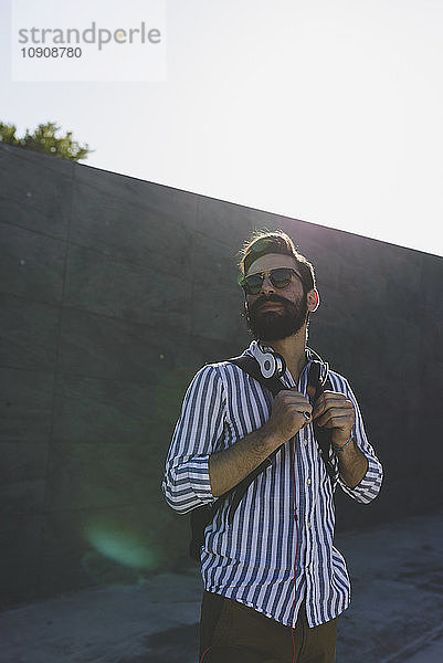 Bearded young man with sunglasses and headphones