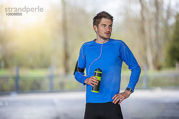 Young sporty man with water bottle