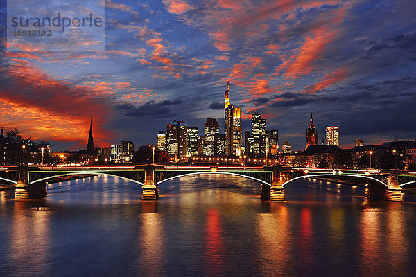 Deutschland  Frankfurt  Blick auf Skyline mit Ignatz-Bubis-Brücke und Main im Vordergrund bei Sonnenuntergang