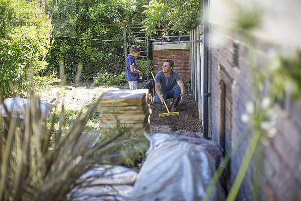 Vater und Sohn arbeiten zusammen im Garten