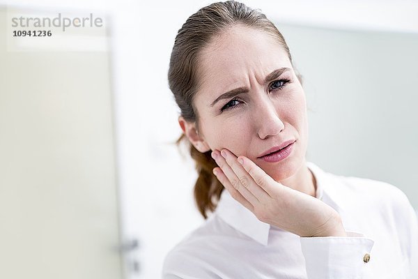 Junge Frau mit Zahnschmerzen