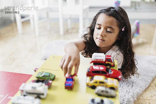 Kleines Mädchen spielt mit Spielzeugauto in der Kindertagesstätte