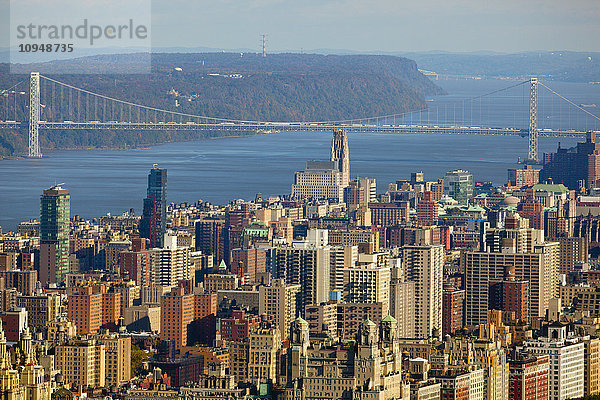 Blick auf die Wolkenkratzer von New York City mit einer Brücke im Hintergrund