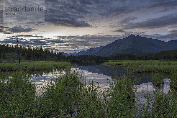 Die Sonne geht über einem kleinen Teich unter  der am Wind River im Peel Watershed liegt; Yukon  Kanada