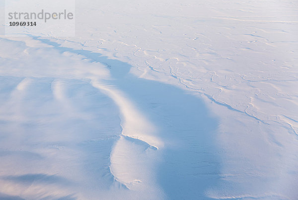 Luftaufnahme von schneebedeckten Hügeln  die bei Sonnenuntergang Schatten werfen  North Slope  Arctic Alaska  USA  Winter