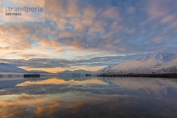 Schiffe liegen im Hafen von Valdez  während die Sonne an einem ruhigen Winterabend untergeht  Southcentral Alaska