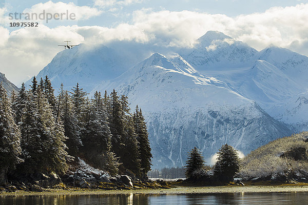 Ein Flugzeug setzt zur Landung auf dem Flughafen Valdez an  während es über Dock Point fliegt; Alaska  Vereinigte Staaten von Amerika'.