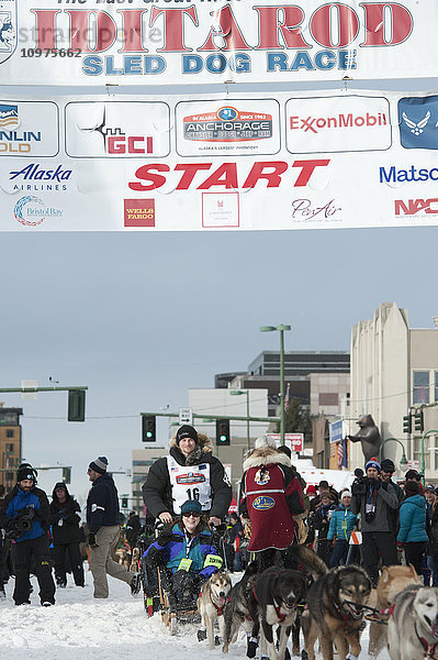 Dallas Seavey und sein Team verlassen die feierliche Startlinie mit einem Iditarider während des Iditarod 2016