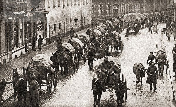 Eine Reihe von Wagen und zerschlagenen deutschen Truppen marschieren am Ende des Ersten Weltkriegs auf dem Rückzug durch Belgien. Aus The Pageant of the Century  veröffentlicht 1934
