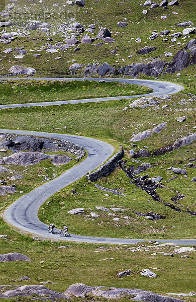 Radfahrer auf der kurvenreichen Straße am Healy Pass; Grafschaft Cork  Irland'.