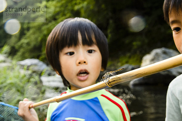 Japanische Kinder spielen am Fluss