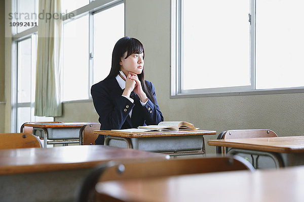 Japanischer Gymnasiast in leerem Klassenzimmer