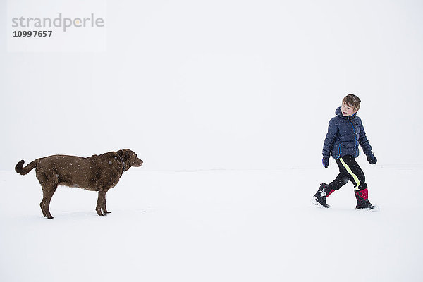 Junge (6-7) beim Spaziergang mit Hund