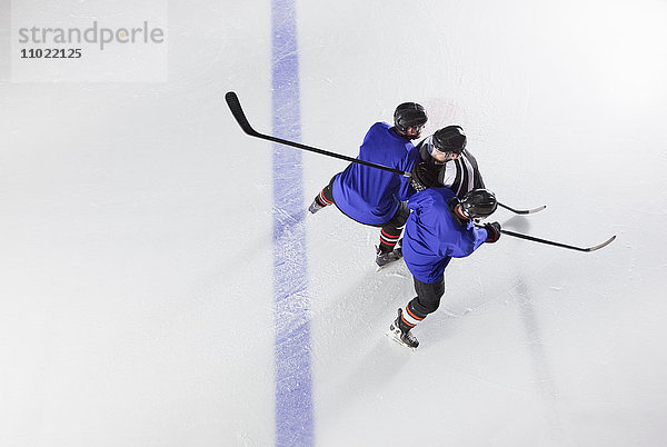 Hockeyspieler blockieren Gegner auf dem Eis