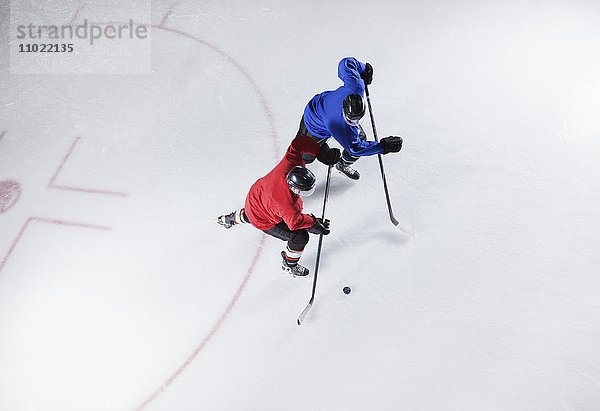 Eishockeyspieler auf dem Weg zum Puck auf dem Eis