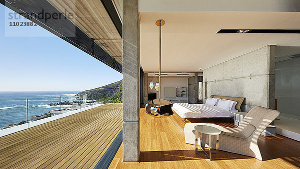 Modernes  luxuriöses Schlafzimmer mit Zugang zur Terrasse und sonnigem Meerblick