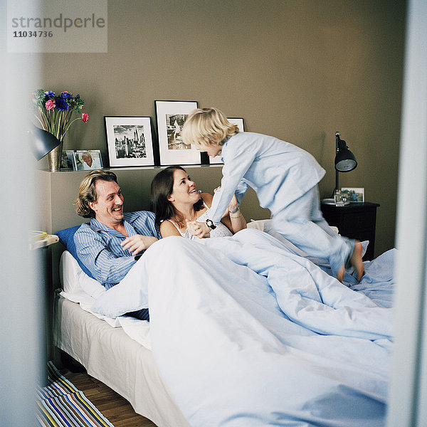 Skandinavische Familie beim Entspannen im Bett  Hammarby sjostad  Schweden.