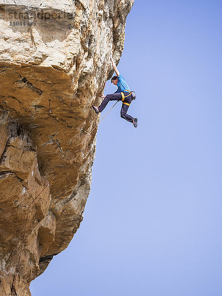Kaukasischer Mann klettert auf Felsen