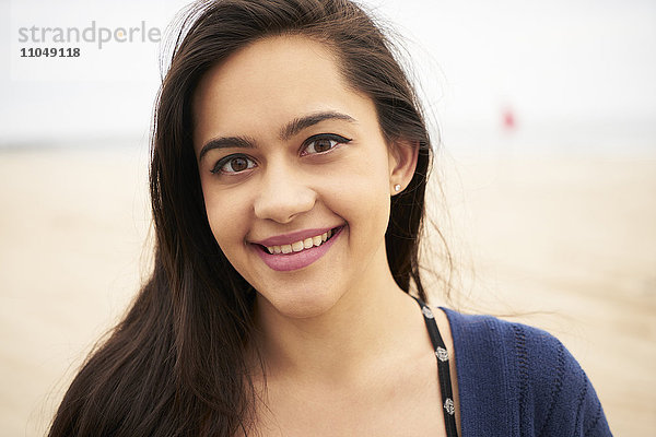 Mixed Race Frau lächelnd am Strand