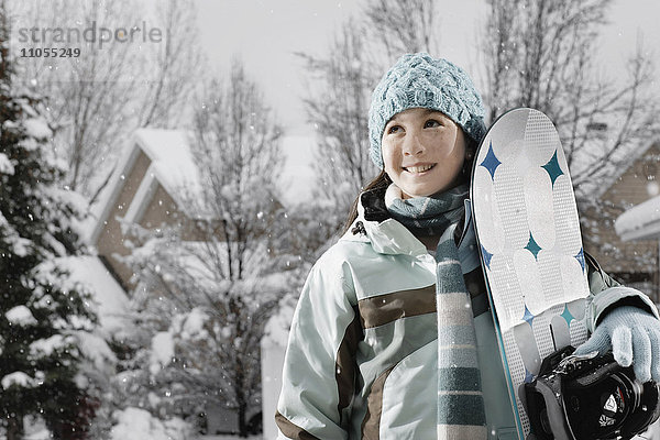 Schnee im Winter. Ein Mädchen mit einem Snowboard.