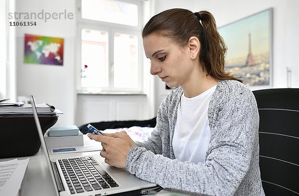 Studentin mit Smartphone und Notebook  Baden-Württemberg  Deutschland  Europa