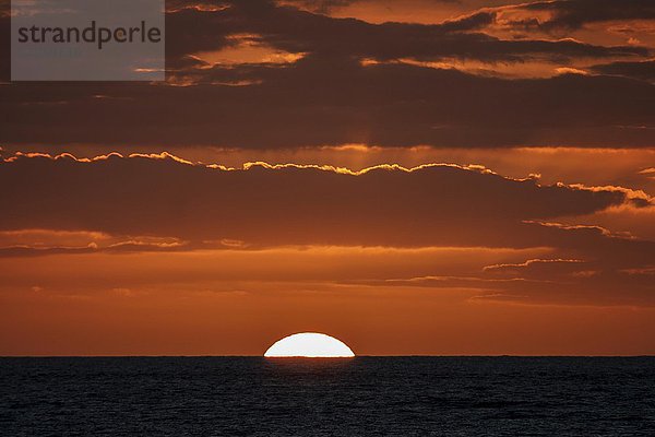 Sonnenuntergang mit Wolken  Sonne versinkt im Meer  bei Saint-Gilles-Les-Bains  La Réunion  Afrika