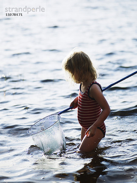 Ein Mädchen spielt im Wasser  Schweden.